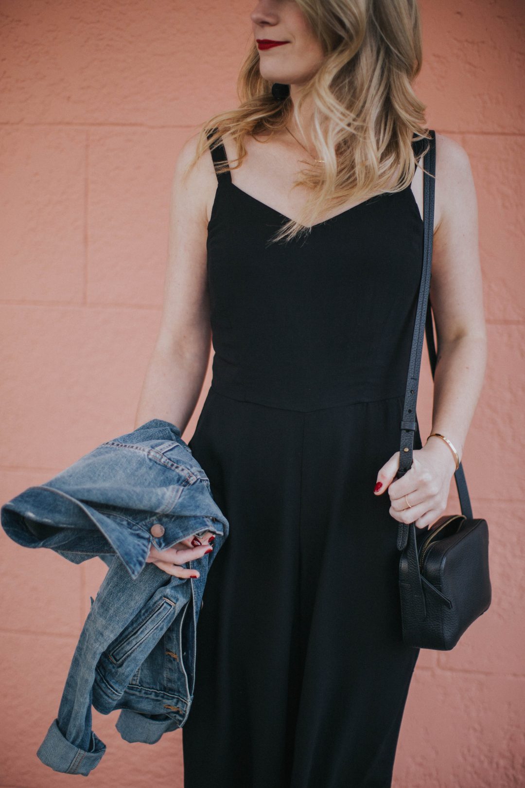 Blogger Cait Weingartner of Pretty & Fun wearing Old Navy culotte jumpsuit with M. Gemi sandals and a GAP denim jacket.